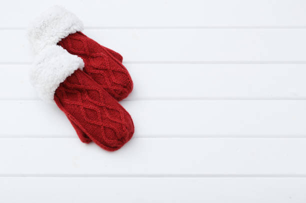 red mittens on wooden background