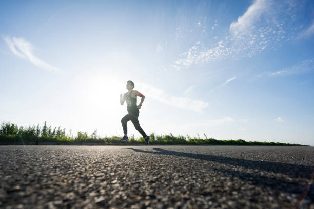 istock young male runner running on asphalt road against sky 862163560