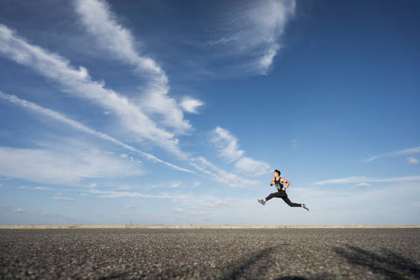 istock young male runner running on asphalt road against sky 862163762