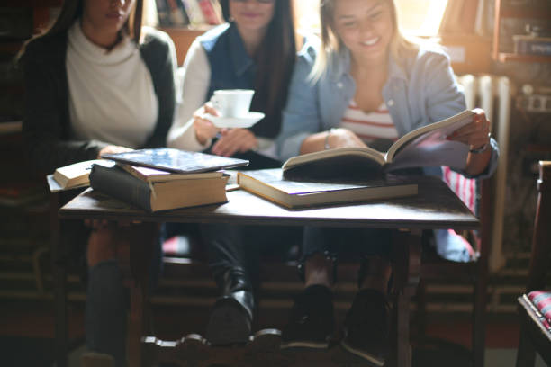 istock Three students girls teaching in cafe. Focus on foreground. 862167566