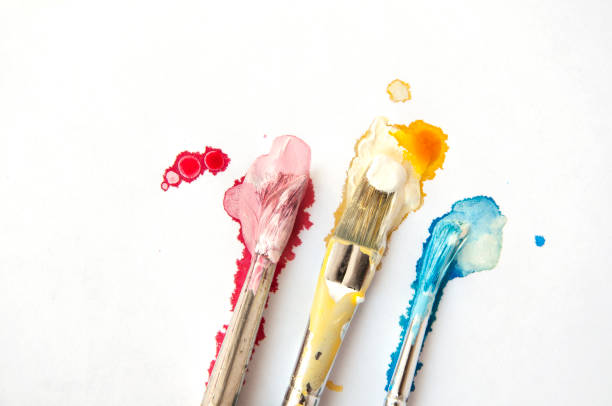 istock Three brushes in Cyan, Magenta, Yellow paint on white background. 862175794