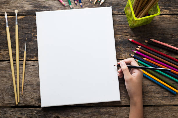 istock Empty white  paper and colorful pencils on old wooden table 862179310