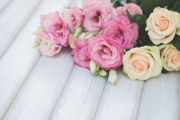 istock Fresh pink flowers frame on wooden background 862179450