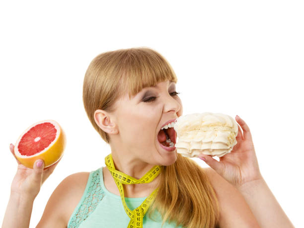 istock Woman choosing fruit or cake make dietary choice 862179984