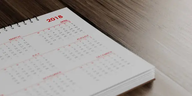 Photo of White Calendar On  Brown Wood Surface