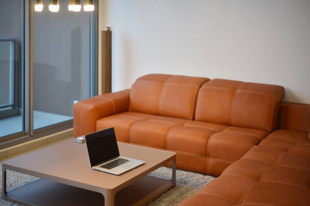 istock Laptop on table in modern living room with blank screen 862184758