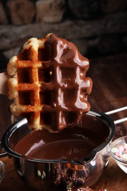 Belgium waffles with chocolate sauce. popsicles with chocolate and wafer