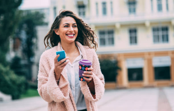 istock Woman texting and drinking coffee in the city 862192320