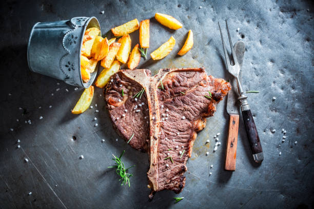istock Yummy tbone steak and chips with salt and rosemary 862192796