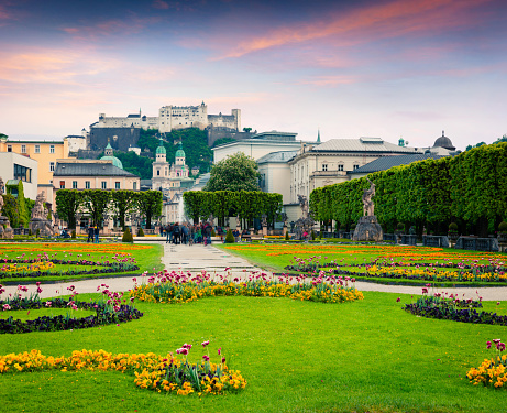 Evening view of Salzburg Cathedral and old historic Fortress Hohensalzburg from Mirabell Garden