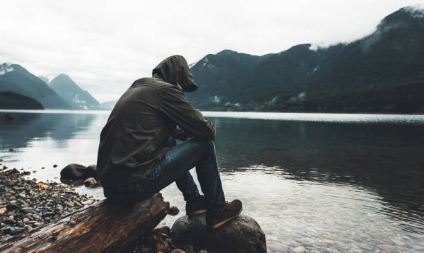istock solitude man sitting on the river in british columbia 862195812