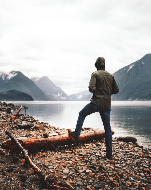 solitude man standing and looking away solitude man standing and looking away spirituality adventure searching tranquil scene stock pictures, royalty-free photos & images