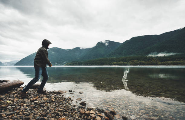 istock man throwing a rock in the lake 862195952