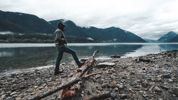 solitude man standing and looking away solitude man standing and looking away spirituality adventure searching tranquil scene stock pictures, royalty-free photos & images