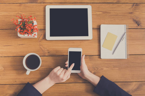 istock Top view closeup of woman using phone at workplace 862199026