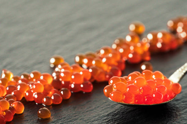 istock red caviar in a spoon on a black slate background 862199760