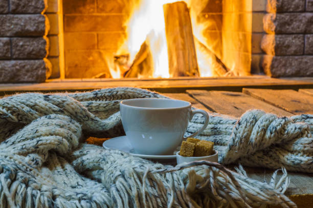 istock Cup of tea and sugar,  woolen things near  cozy fireplace. 862200542