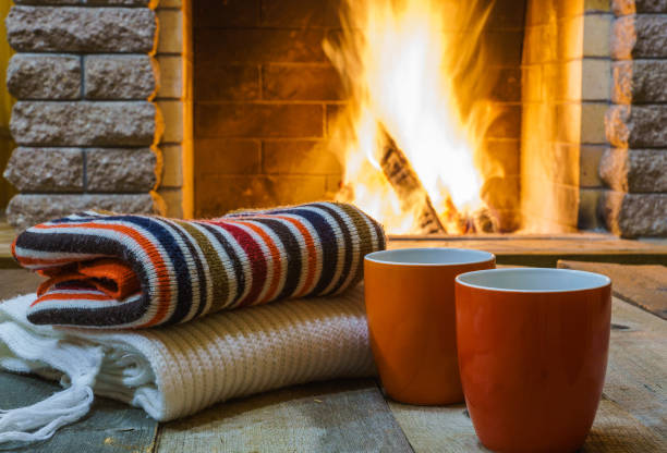 istock Two  mugs  for tea or coffee,  woolen things near  cozy fireplace. 862200546