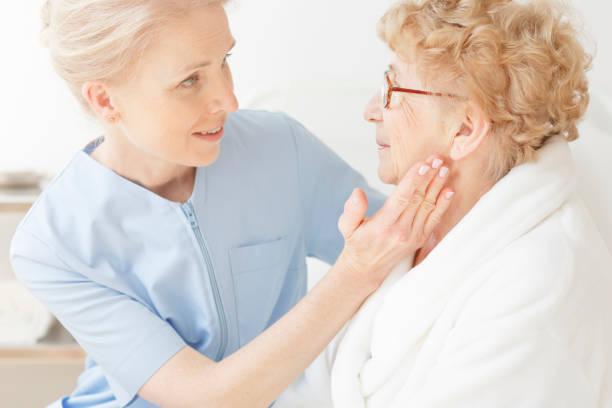 istock Friendly nurse comforting elderly woman 862200748