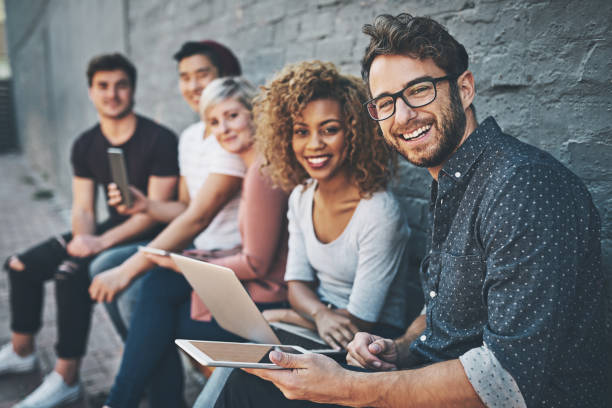 The social networking row Shot of a diverse group of people social networking outside group of people wearing eyeglasses stock pictures, royalty-free photos & images