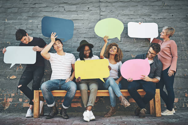 If you want to say something, say it here Shot of a diverse group of people holding up speech bubbles outside commercial sign photos stock pictures, royalty-free photos & images