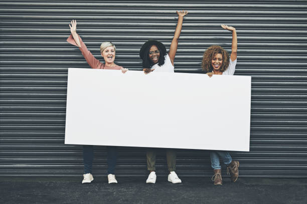 say yes to displaying your message here - placard women holding standing imagens e fotografias de stock