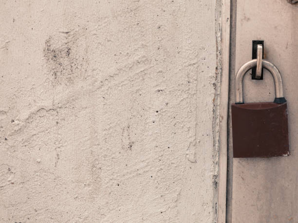 istock Old fashioned padlock on light grey steel door 862202630
