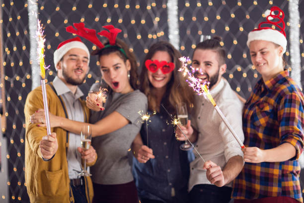 istock Three women and two man burning fireworks at the winter party 862206210