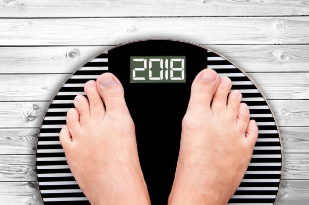 istock 2018 feet on a weight scale isolated on white background 862208980