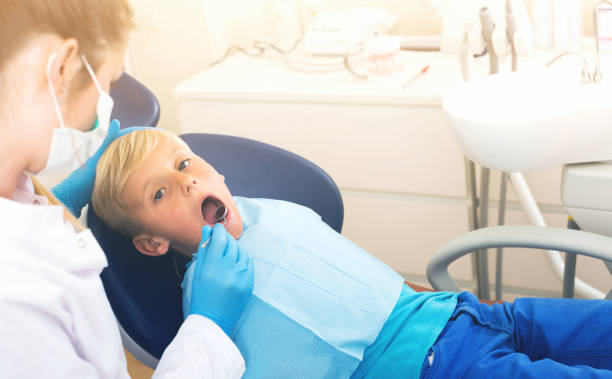 istock Stomatologist in uniform is taking a view of a young child 862209234