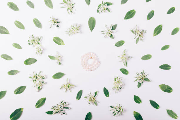 istock Pearl bracelet on white table among the green leaves 862209826