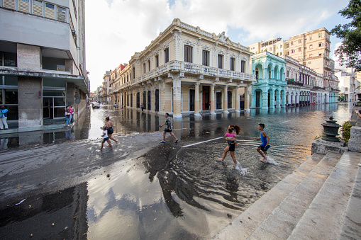 Paseo del Prado Was Flooded, Havana, Cuba. the main street of Old Habana. People are walking throungh the water to pass the flooded area.