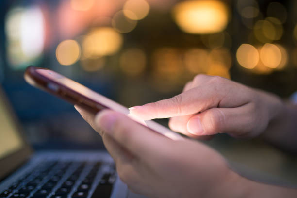 istock Woman using smartphone and laptop at night 862213262