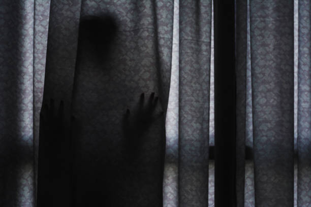 istock horror scene of woman's shadow standing hiding behind curtain 862218846