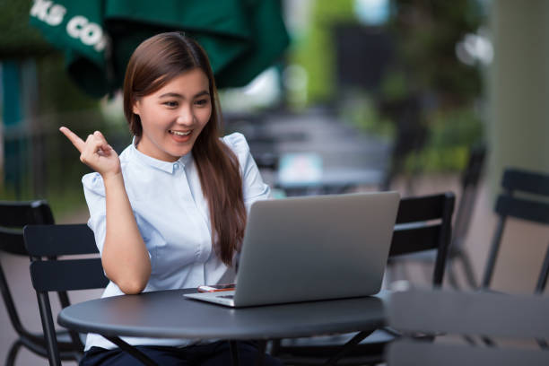 istock Happy woman using laptop at cafe 862221568