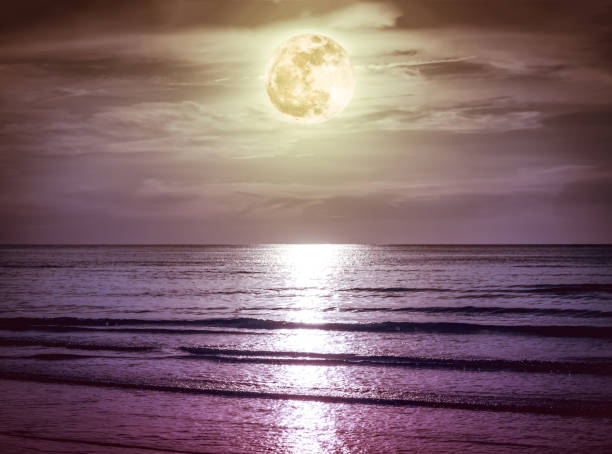 istock Colorful sky with dark cloud and bright full moon over seascape. 862222044