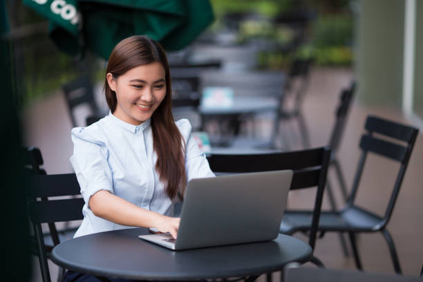 istock Happy woman using laptop at cafe 862222130