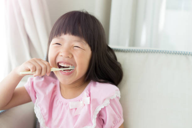 istock cute girl brush teeth 862222488