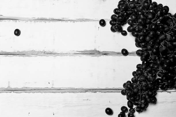 Grapes lying on a wooden table black and white poster