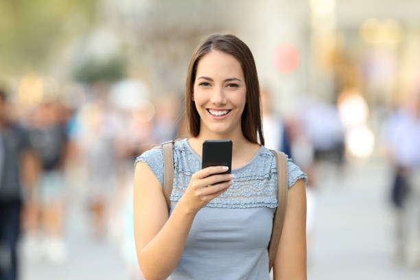 istock Happy woman holding a phone looking at camera 862228966