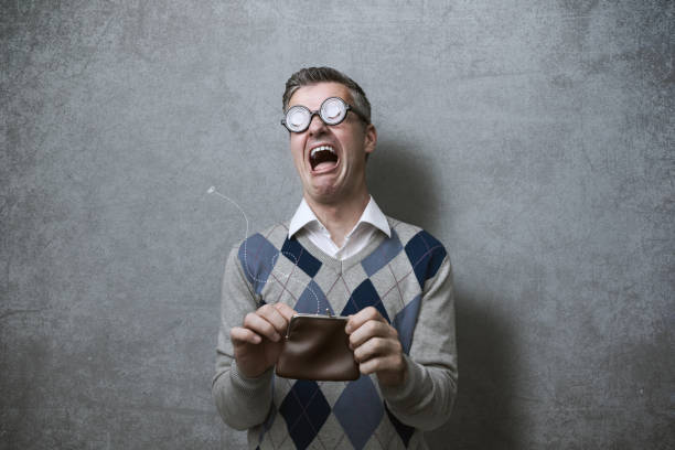 Broke man with empty purse Broke man with thick glasses holding an empty purse and crying, poverty and debts concept money cry stock pictures, royalty-free photos & images