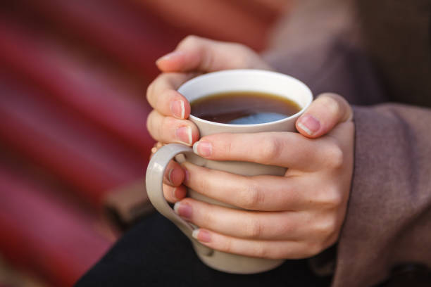 istock Fall concept - autumn woman drinking coffee on park bench under fall foliage 862235546