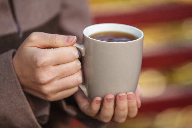 istock Fall concept - autumn woman drinking coffee on park bench under fall foliage 862235634