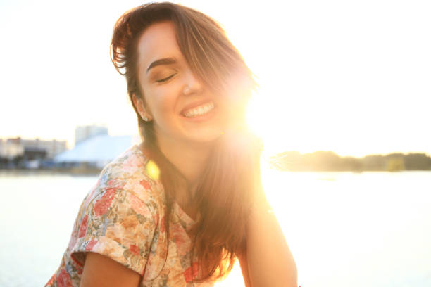 istock Woman with white teeth thinking and looking sideways in a park in summer 862238006