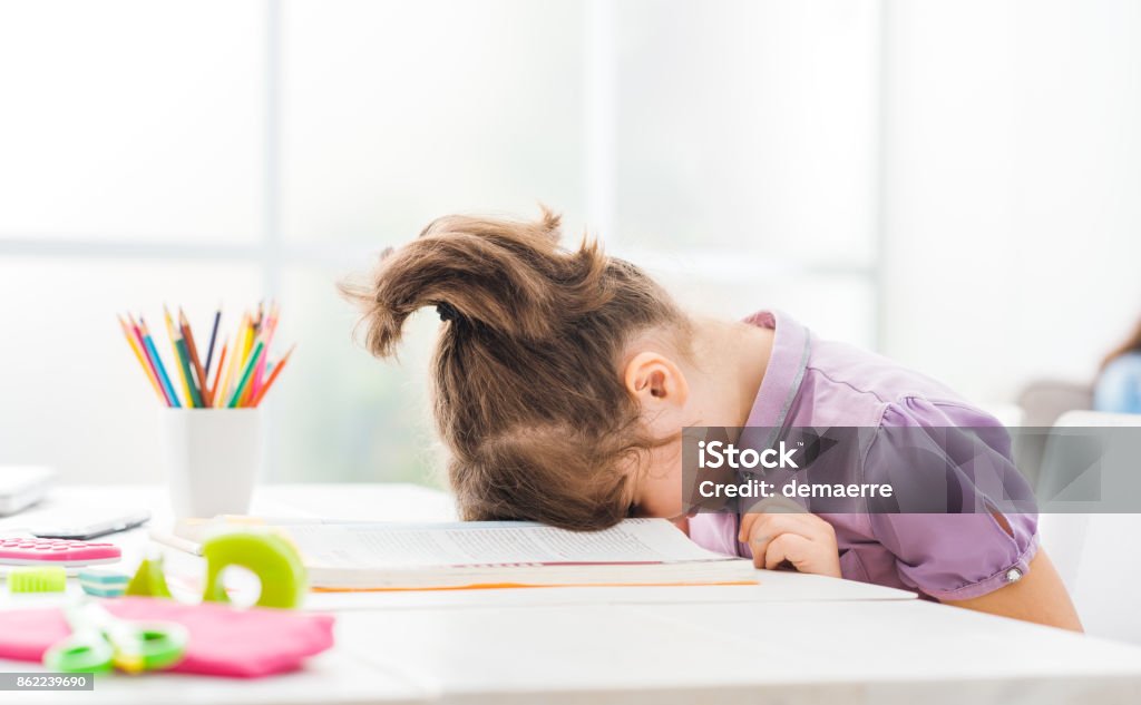 Lazy student girl at home Lazy student girl at home, she is resting with her face down on the school book, education and childhood concept Child Stock Photo