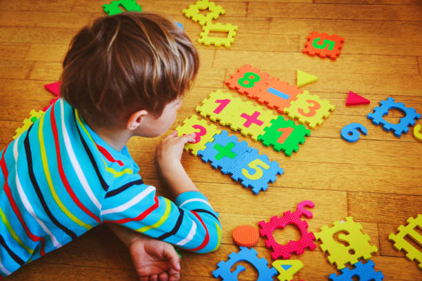 istock little boy playing with puzzle, education concept 862240052