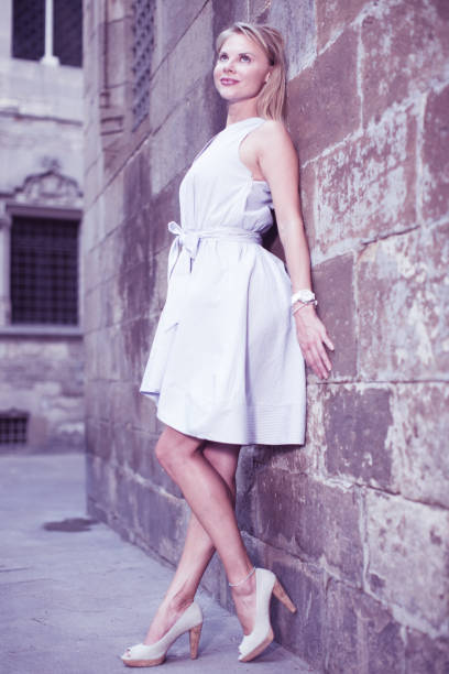 istock smiling woman near the stone wall 862245336