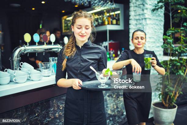 Waiters Carrying Plates With Food In A Restaurant Stock Photo - Download Image Now