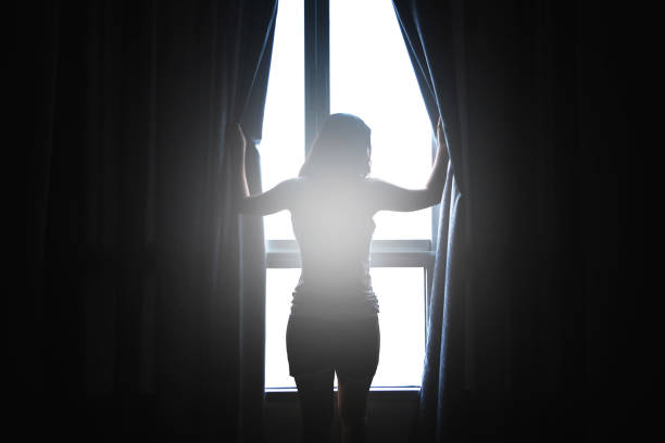 istock woman open window’s curtain in the morning 862249928
