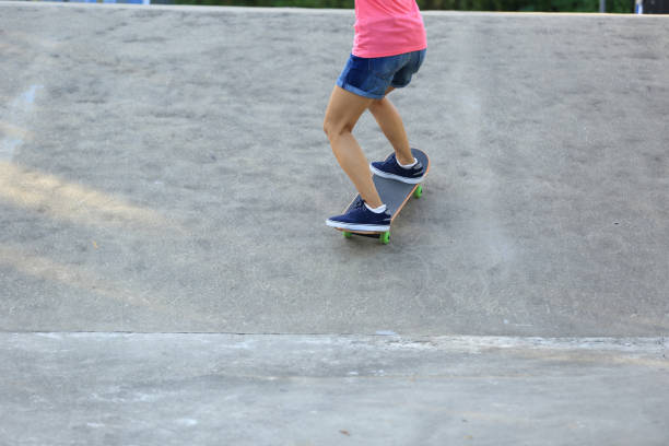 istock Skateboarder legs riding skateboard at skatepark 862250796